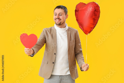 Handsome man with balloon a...