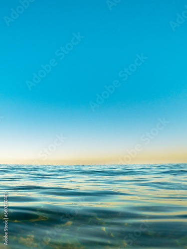 ocean surface with reflection of blue sky