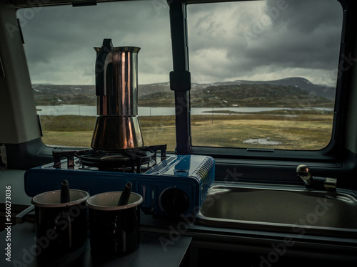 Morning coffee in the campervan in Jotunheimen National Park in Norway, moody weather outside