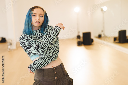 Image of caucasian female hip hop dancer posing to camera with copy space