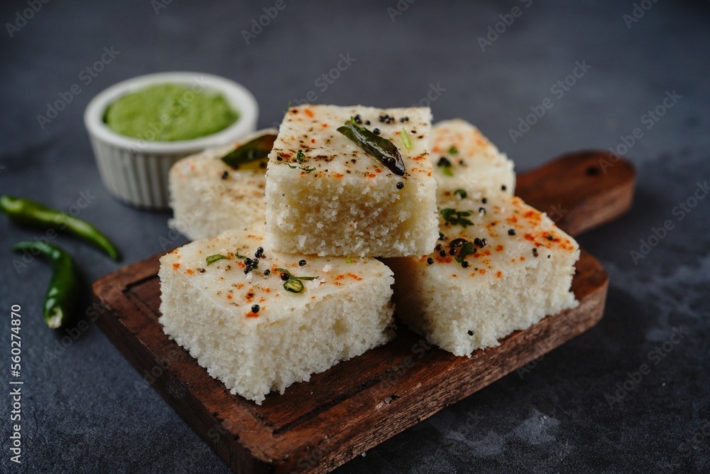 Spongy white dhokla - popular Gujarati steamed breakfast with rice or rava served with green chutney Spongy white dhokla - popular Gujarati steamed breakfast with rice or rava served with green chutney