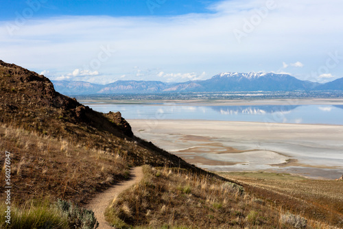 Farmington bay in 2016 as seen from Antelope island with Wasatch mountain front reflected in water with salt and algae coast line in Davis county, Utah