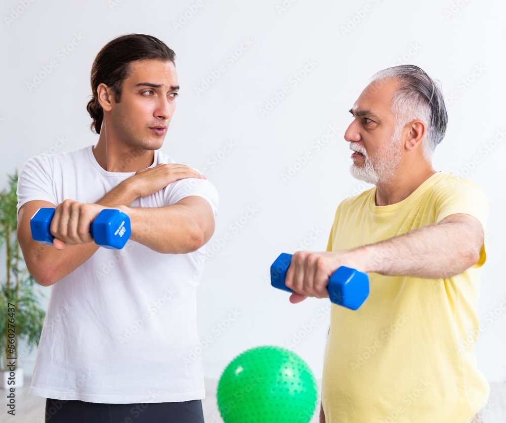 Old man doing exercises indoors Old man doing exercises indoors