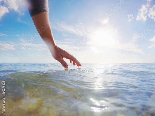 Hand delicately touching the water