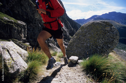 Man trail running in Val De Malatra, Courmayeur, Italy. photo