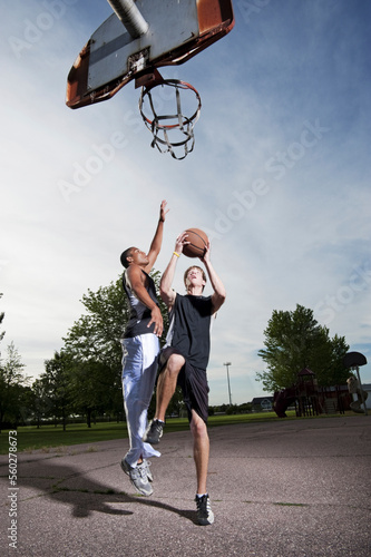 Two young men play one on one Basketball at Barstow Park in Vermillion, South Dakota (lit with flash). photo