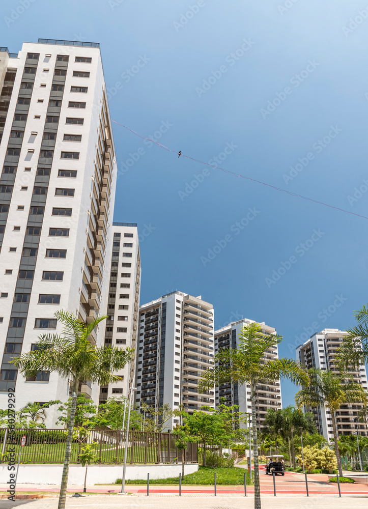 Man highlining between skyscrapers, Olympic Village, Barra Da Tijuca, Rio de Janeiro, Brazil Man highlining between skyscrapers, Olympic Village, Barra Da Tijuca, Rio de Janeiro, Brazil