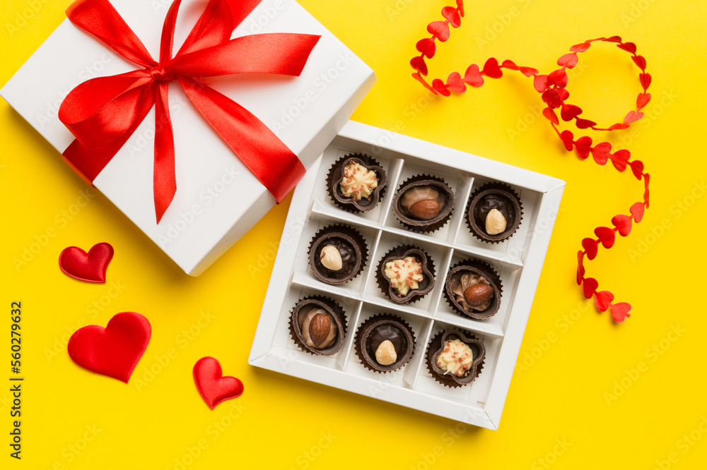 Delicious chocolate pralines in red box for Valentine's Day. Heart shaped box of chocolates top view with copy space Delicious chocolate pralines in red box for Valentine's Day. Heart shaped box of chocolates top view with copy space