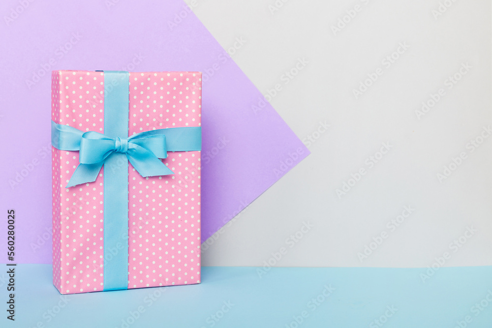 holiday handmade paper present tied blue ribbon bow top view with copy space. Flat lay holiday background. Birthday or christmas present. Christmas gift box concept with copy space holiday handmade paper present tied blue ribbon bow top view with copy space. Flat lay holiday background. Birthday or christmas present. Christmas gift box concept with copy space