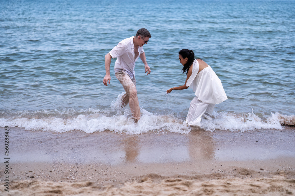 Love couple on holiday happy playing running along the beach and sweet kiss on love emotion Love couple on holiday happy playing running along the beach and sweet kiss on love emotion