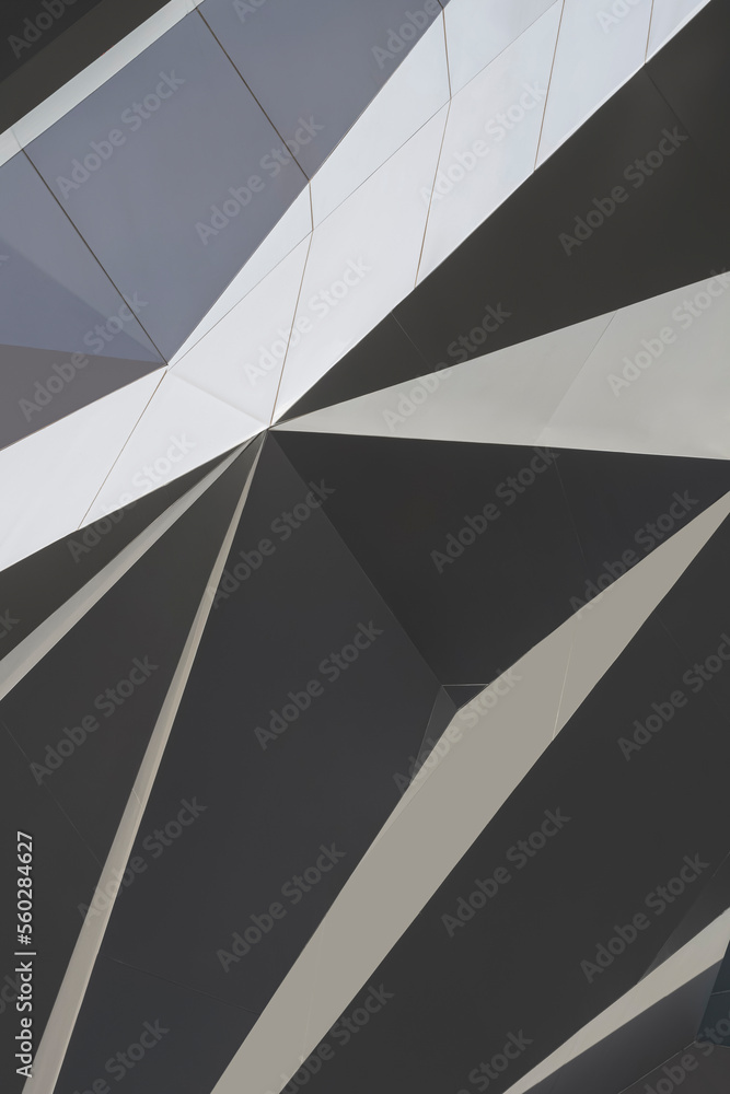 Aluminum composite tiles wall outside of modern building with light and shadow on surface in monochrome style and vertical frame Aluminum composite tiles wall outside of modern building with light and shadow on surface in monochrome style and vertical frame