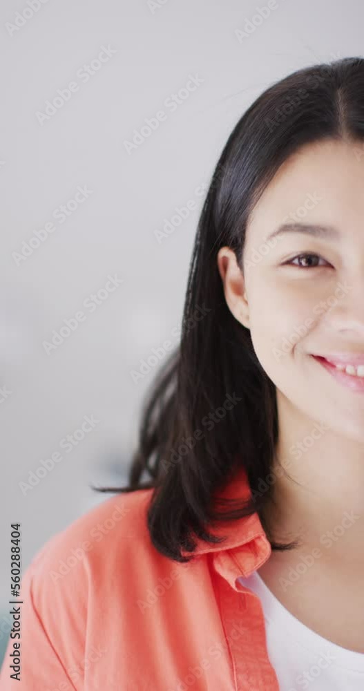 Vertical video of smiling biracial woman with dark hair looking at camera Vertical video of smiling biracial woman with dark hair looking at camera