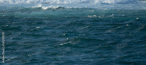 Fotografie Choppy ocean waves background. Blue water banner.
