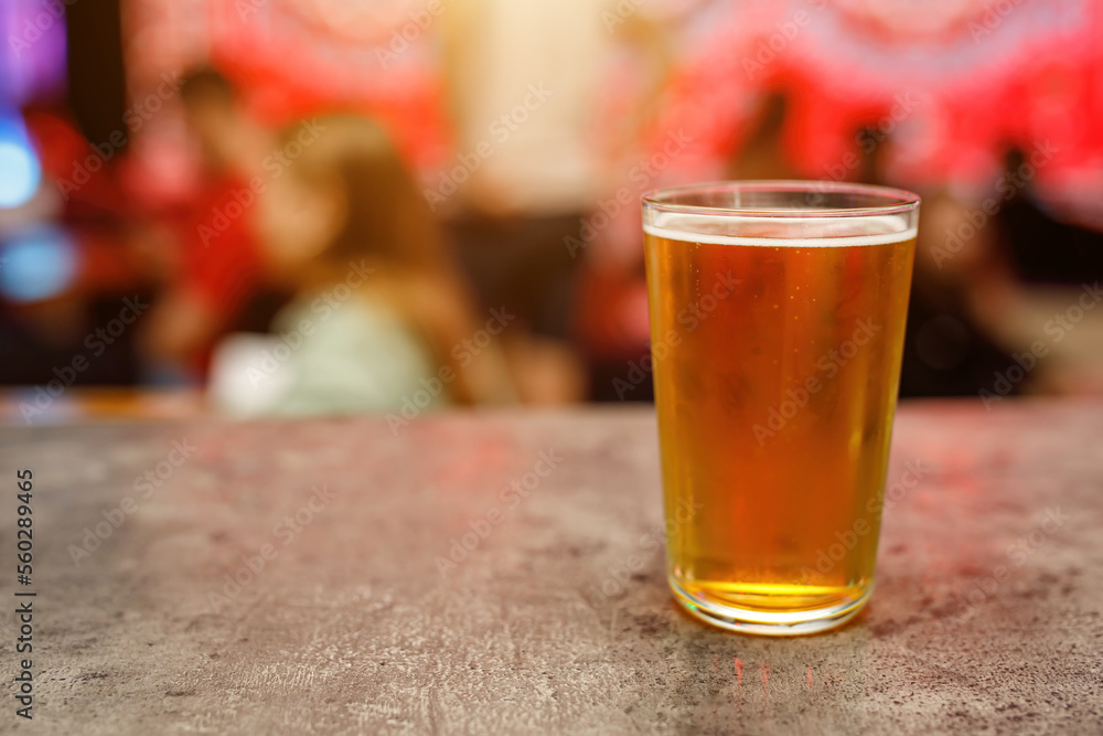 A glass of cold draft beer in a pub. A glass of cold draft beer in a pub.