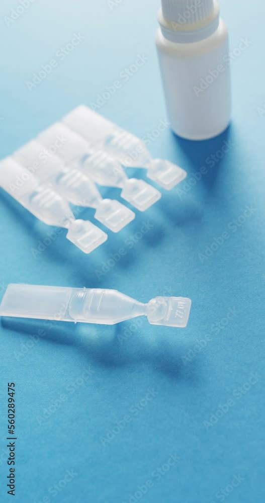 Vertical video of medical drops and test tubes on blue background Vertical video of medical drops and test tubes on blue background