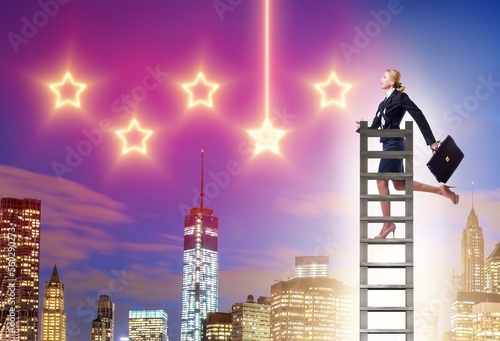 Businesswoman reaching out for stars in success concept © Elnur