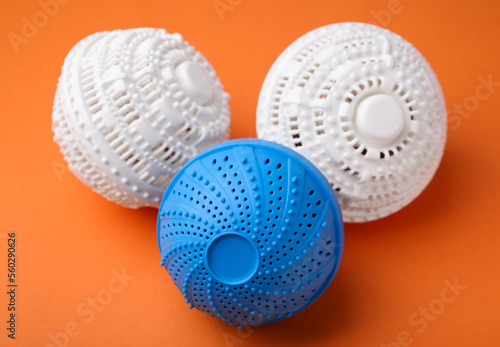 Dryer balls for washing machine on orange background. Laundry detergent substitute