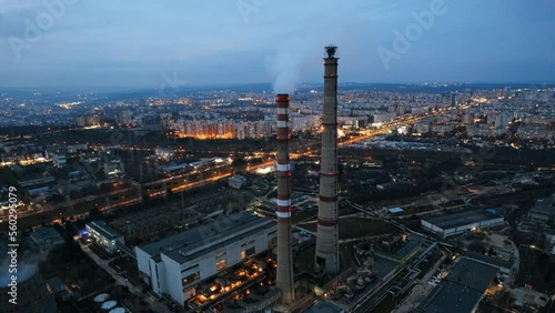 Wallpaper Mural Aerial drone timelapse view of thermal power plant in Chisinau at cloudy weather, Moldova. View of pipes with felling steam, cityscape, illumination, sunset Torontodigital.ca