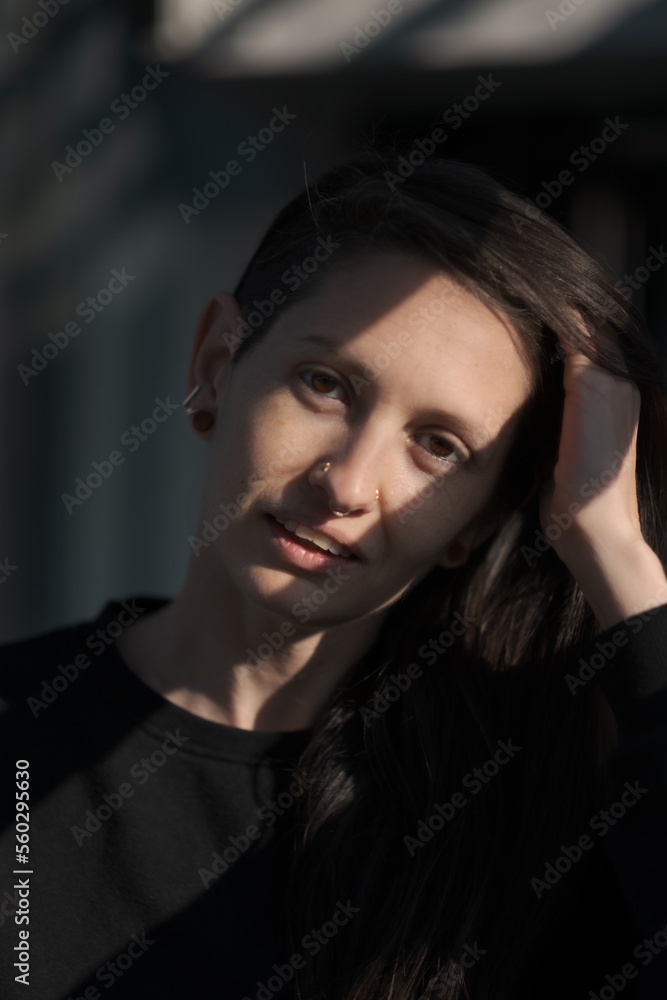 A model (they/them, White) expresses a subtle smile. A model (they/them, White) expresses a subtle smile.