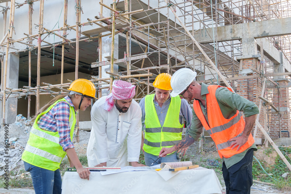 Diverse team of professionals using tablet computers on construction site. Real estate construction project. with civil engineers, architects, Arabic business investors and explorer with theodolite Diverse team of professionals using tablet computers on construction site. Real estate construction project. with civil engineers, architects, Arabic business investors and explorer with theodolite