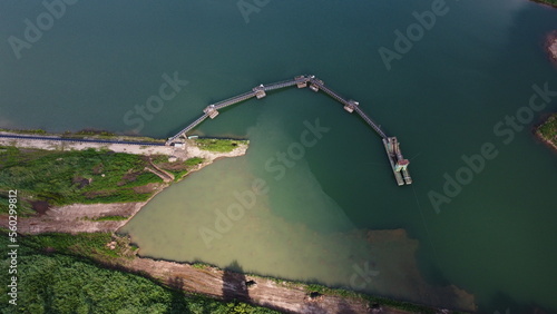 Aerial view of floating dredgers operating in a flooded sand quarry, showcasing industrial mining techniques and the scale of modern quarrying operations