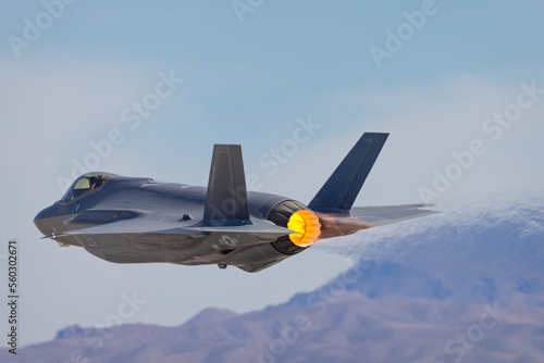 Extremely close view of a F-35 Lightning II against the Nevada hills, with afterburner on photo