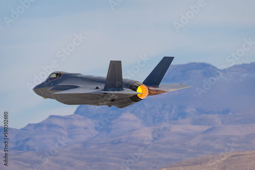 Extremely close view of a F-35 Lightning II against the Nevada hills, with afterburner on