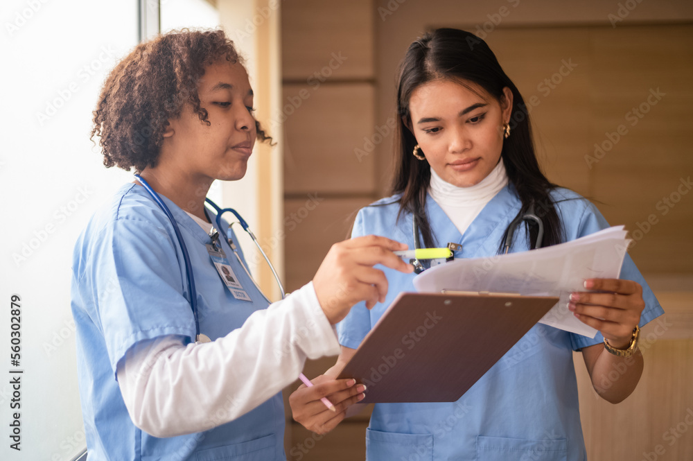 Nurse student Multi-ethnic group of happy nursing students talking medical university corridor.