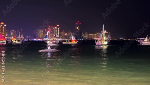 Doha's luxury towers, World Cup yachts and an old Arab man in a native boat on the Cornish coast.The night life of fishermen is very attractive. Qatar tried to show this to tourists. photo