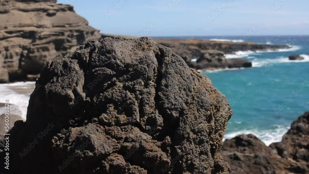 Waves Crash Against Shore behind Black Rocks on Green Sand Beach in Hawaii Waves Crash Against Shore behind Black Rocks on Green Sand Beach in Hawaii