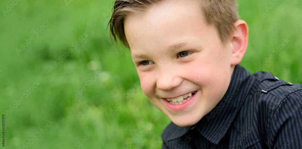 Close up portrait of cute child outdoors. Spring banner for website header. Happy child, adorable kid boy. Spring and kid. Banner for website header. Close up portrait of cute child outdoors. Spring banner for website header. Happy child, adorable kid boy. Spring and kid. Banner for website header.