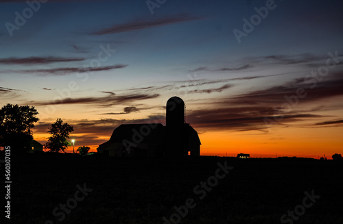 Silhouette of a Barn and Farm House at Sunset in the Mid West