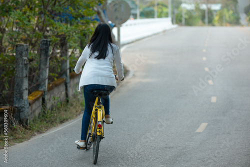 Wallpaper Mural a girl in a white short dress riding a yellow bicycle Torontodigital.ca