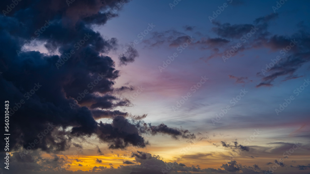 The evening sky is painted in fantastic colors - blue, pink, orange, purple. Picturesque clouds.
