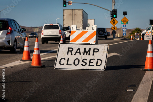 Traffic caused by a sign and cones indicating a freeway onramp is closed