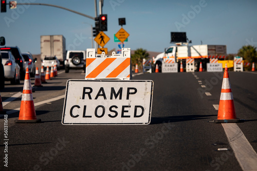 Traffic caused by a sign and cones indicating a freeway onramp is closed
