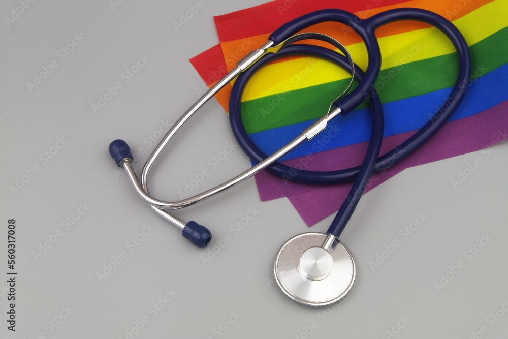 Rainbow LGBT flags and stethoscope on gray background Rainbow LGBT flags and stethoscope on gray background