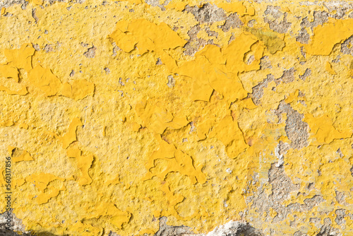 Weathered grunge rough old yellow paint on the wall