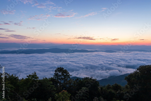 Mountain range with visible silhouettes through the morning colorful fog in Thailand.