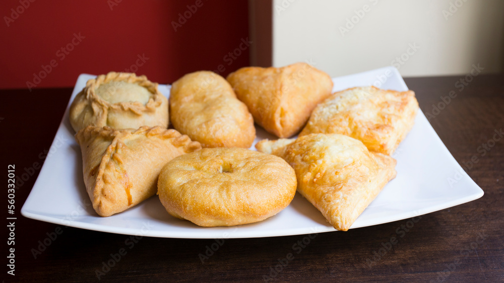 Pirozhki​ are stuffed rolls typical of Russian, Belarusian, and Ukrainian cuisines. They can be baked or fried with yeast. Their fillings are made of meat or vegetables.