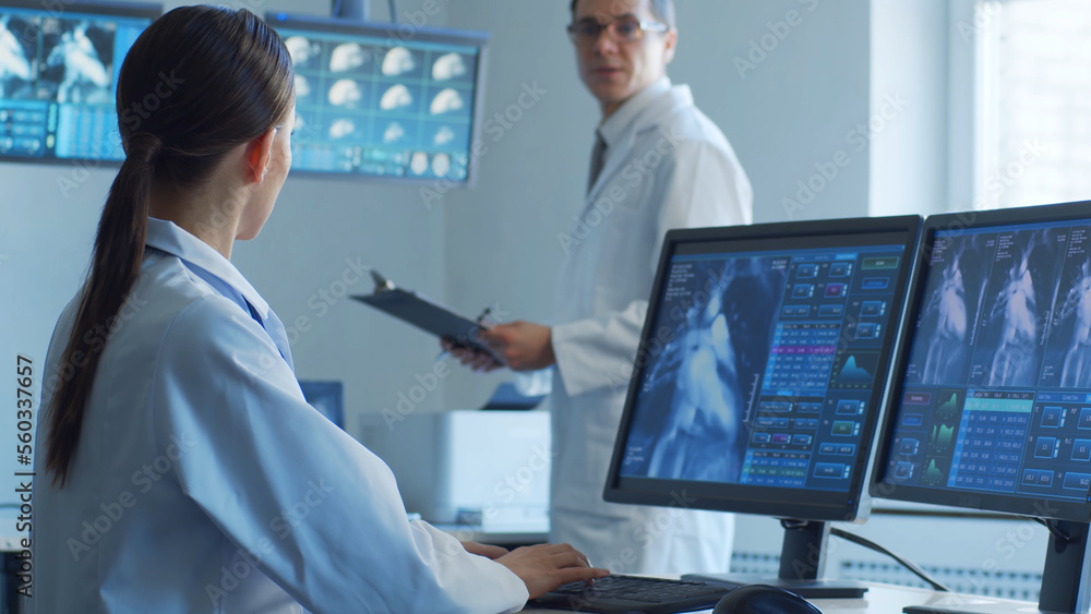 Professional medical doctors are maksing computer research in hospital office. Medicine, healthcare and cardiology concepts. Professional medical doctors are maksing computer research in hospital office. Medicine, healthcare and cardiology concepts.