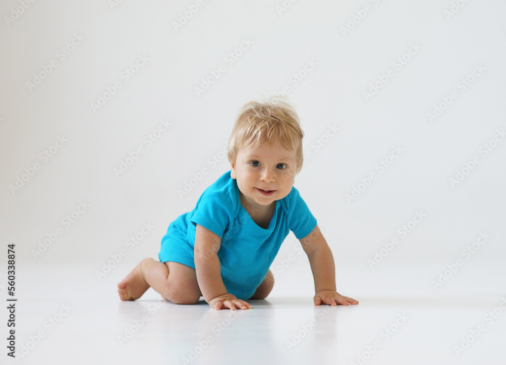 Little, happy and smiling cute baby in the studio. Portrait of a one year old baby. The concept of happiness.