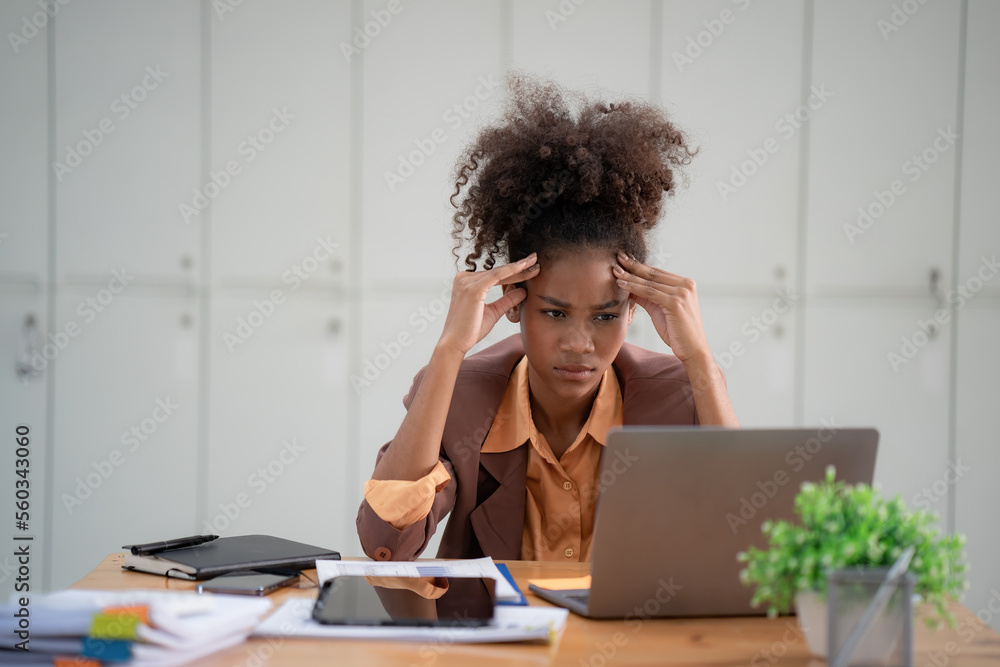 Tired African-American businesswoman with headaches at the office, feeling sick at work, copy space. Tired African-American businesswoman with headaches at the office, feeling sick at work, copy space.