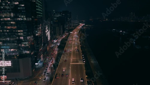 Wallpaper Mural Aerial backwards shot over busy highway in Kwun Tong district at night in Hong Kong. Suspenseful, revealing Torontodigital.ca