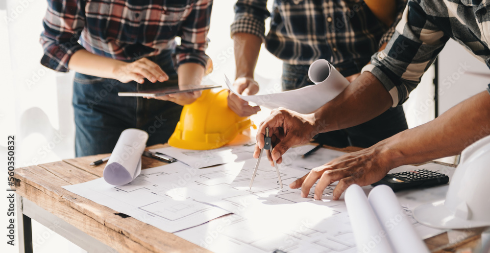Engineer people meeting working in office for discussing, engineering .Hands of Engineer working on blueprint Construction concept.. Engineer people meeting working in office for discussing, engineering .Hands of Engineer working on blueprint Construction concept..