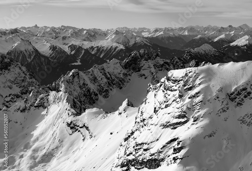 View from the highest summit, the Zugspitze (2962 m) near Garmisch-Partenkirchen Bavaria (in Germany towards south. Austrian alps with snow capped mountain scenery in December. Black and white pano.