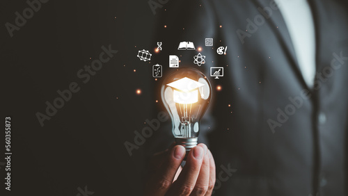 E-learning graduate certificate program concept. man holding lightbulb showing graduation hat, Internet education course degree, study knowledge to creative thinking idea and problem solving solution © Looker_Studio