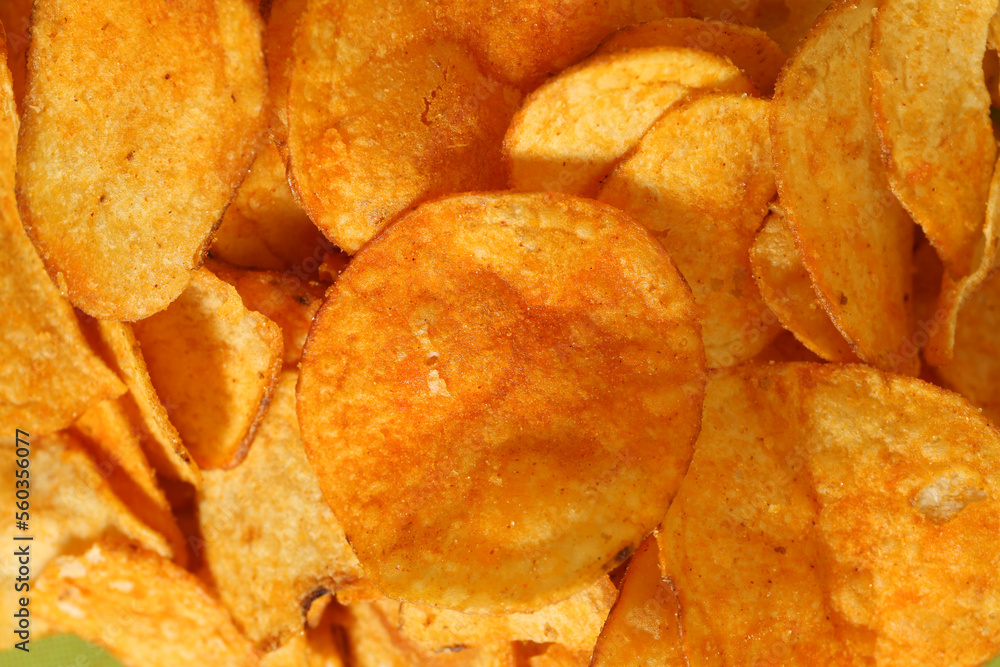 Crispy potato chips as background, closeup view Crispy potato chips as background, closeup view