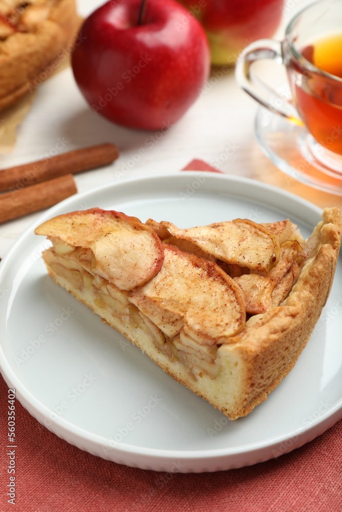 Slice of delicious apple pie served on table, closeup
