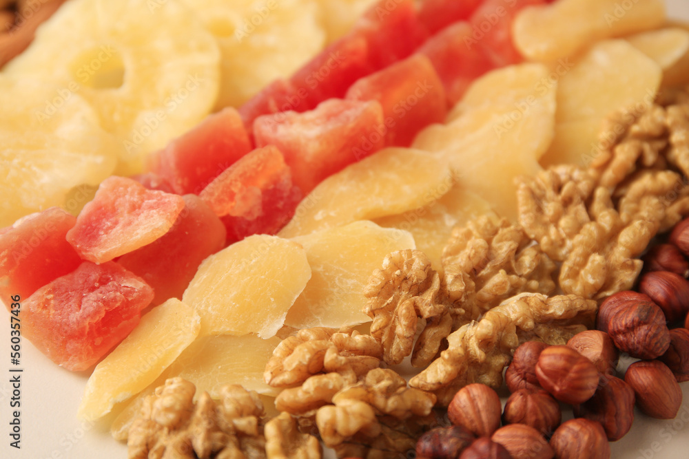 Different tasty nuts and dried fruits on beige background, closeup Different tasty nuts and dried fruits on beige background, closeup